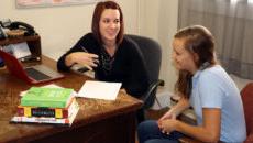 Student meeting with teacher in office